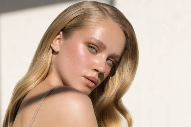 Close up studio shot of a beautiful natural blonde woman. Natural sunlight.