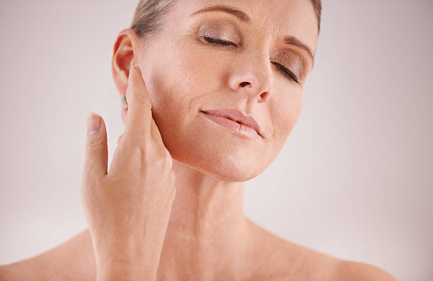 Cropped studio shot of a beautiful mature woman touching her face