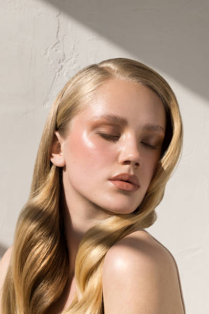 Close up studio shot of a beautiful natural blonde woman with freckles skin.