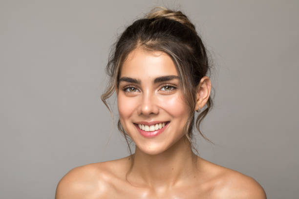 Close up studio shot of a beautiful woman with perfect skin