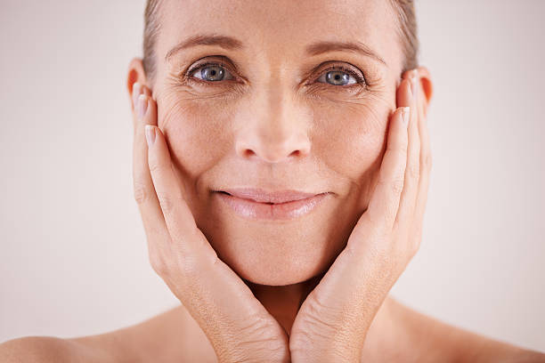 Studio portrait of a beautiful mature woman posing with her head in her hands