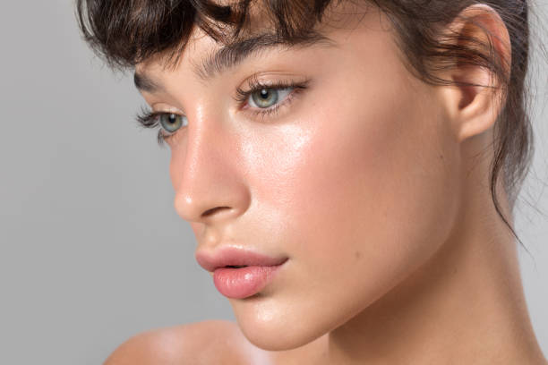 Close up studio shot of a beautiful woman with perfect skin